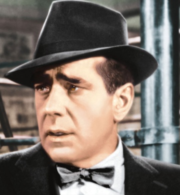 A man dressed in a suit standing in front of metal poles